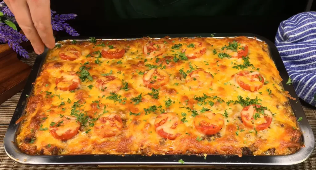 German-style ground beef potato casserole with melted Cheddar mozzarella and fresh orange feta salad