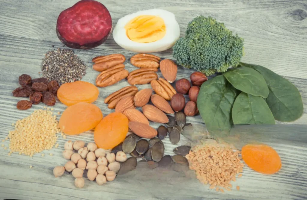 Iron-rich foods including spinach, lentils, chickpeas, raisins, sesame seeds and oranges