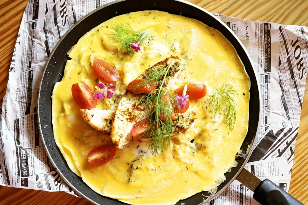The Humble Vegetable Omelette Is Having a Breakfast Comebac And There’s a Good Reason Healthy vegetable omelette with spinach tomato bell pepper and eggs
